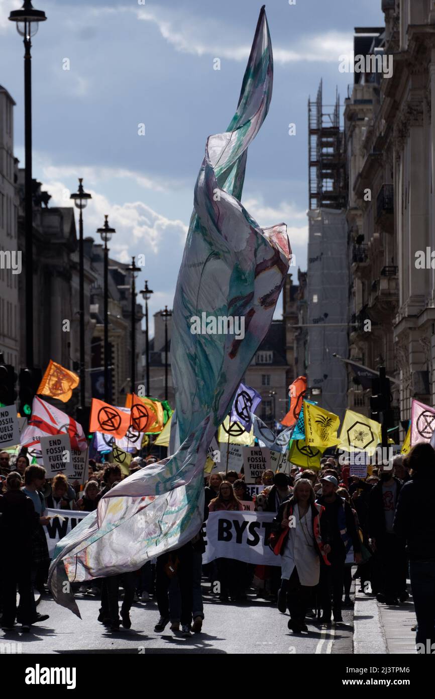 London, UK. 9th Apr, 2022. Extinction Rebellion (XR) activists gathered in Hyde Park and marched through Oxford Street making a stop in Oxford Circus, St James Square where BP is headquartered and finally to Trafalgar Square where traffic was blocked. Today was part of a week long wave of protests and civil disobedience actions to demand an immediate stop to all new fossil fuel infrastructure by the British government amid the climate crisis and ecological emergency. Stock Photo