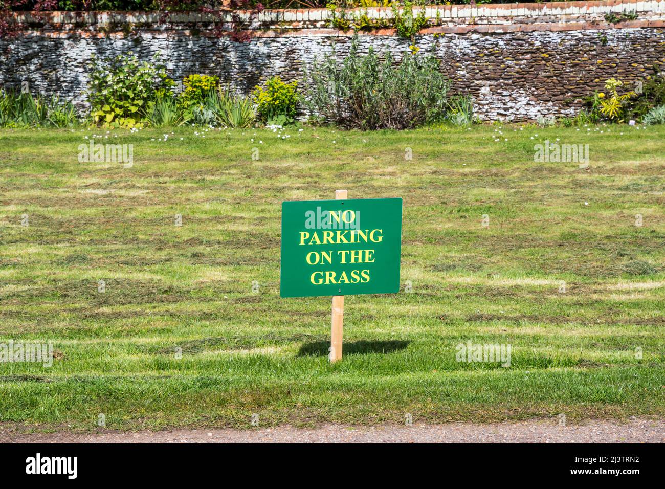 A No Parking on the Grass sign in an English village. Stock Photo