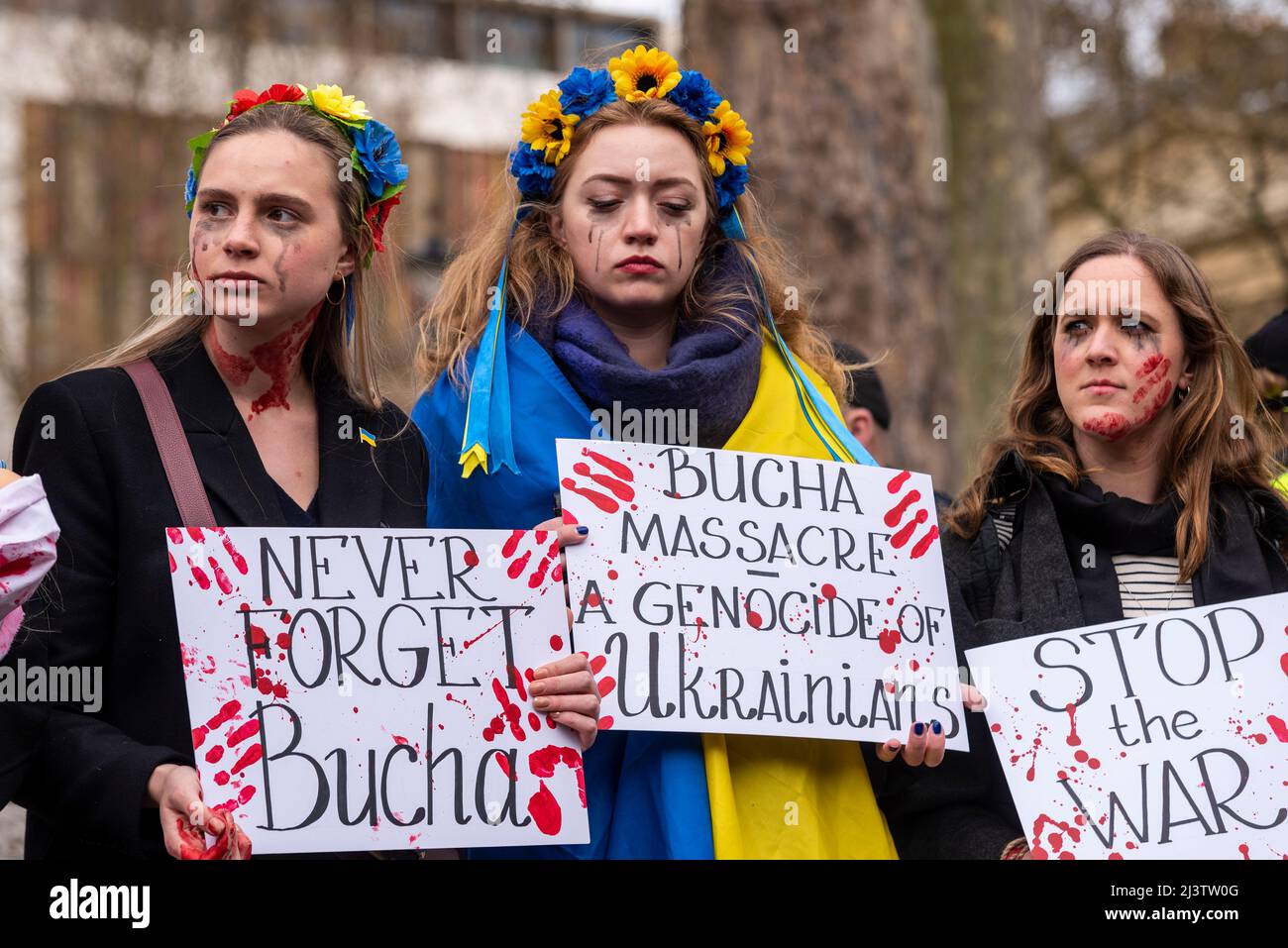 Protesters carrying out a die-in, referencing the killed Ukraine civilians in towns such as Bucha during war with Russia. Women with bloody messages Stock Photo