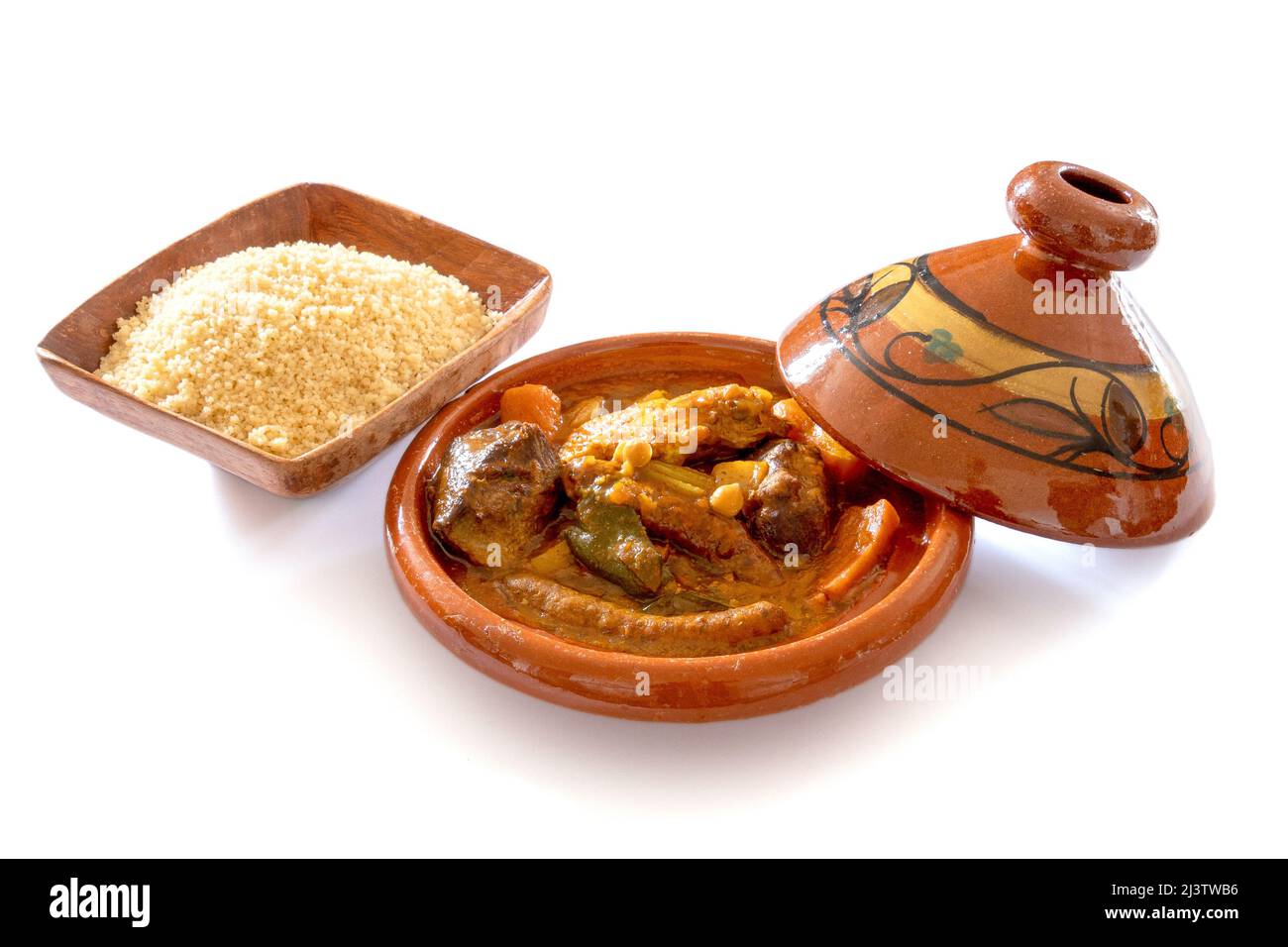 royal couscous in a tagine with a bowl of semolina isolated on a white