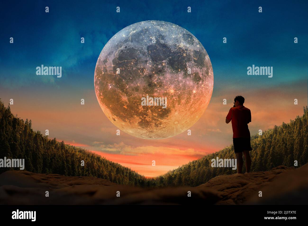 Young Man Is Watching The Full Moon On A Beautiful Sunset Stock Photo Alamy