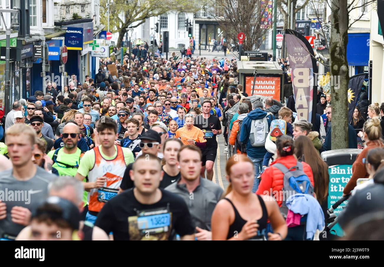 Brighton UK 10th April 2022 - Thousands of runners head through the streets as they take part in the Brighton Marathon today with many raising money for charities : Credit Simon Dack / Alamy Live News Stock Photo