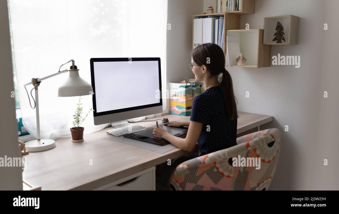 Woman working on pc use digital graphic tablet holds stylus Stock Photo