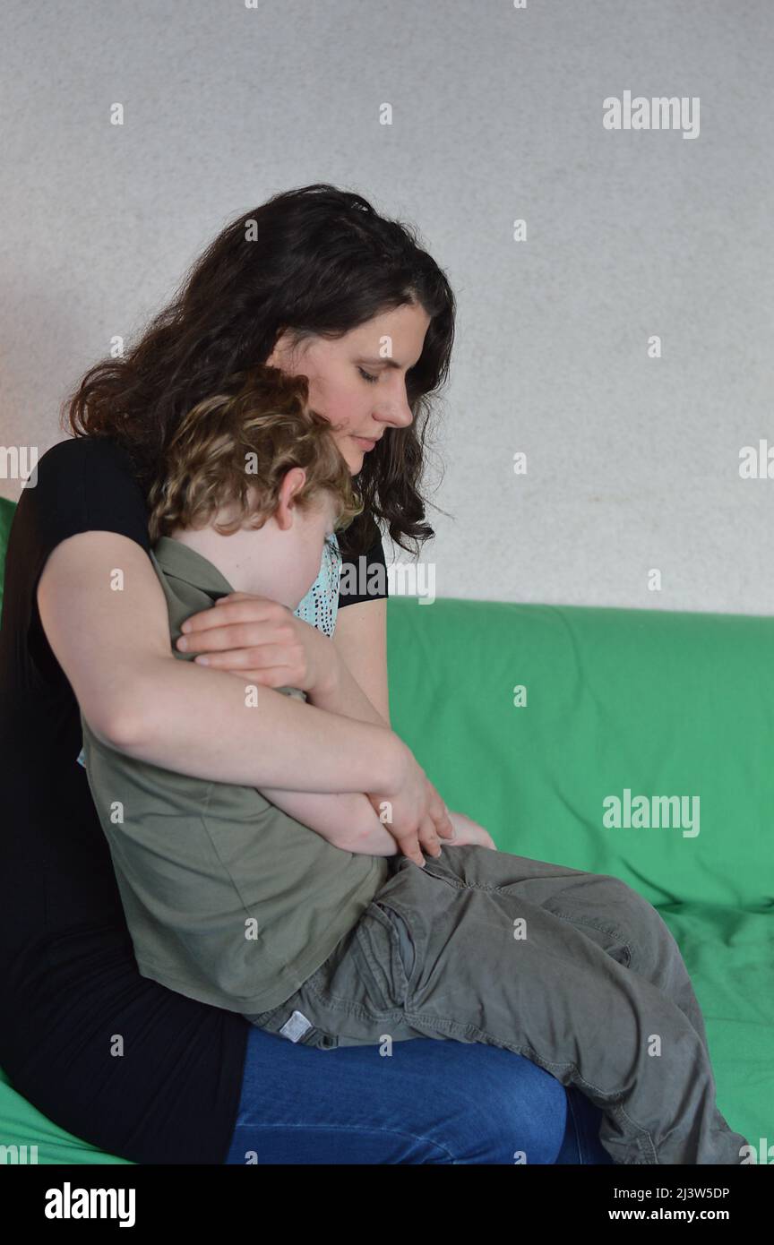 mother holding son in her arms Stock Photo
