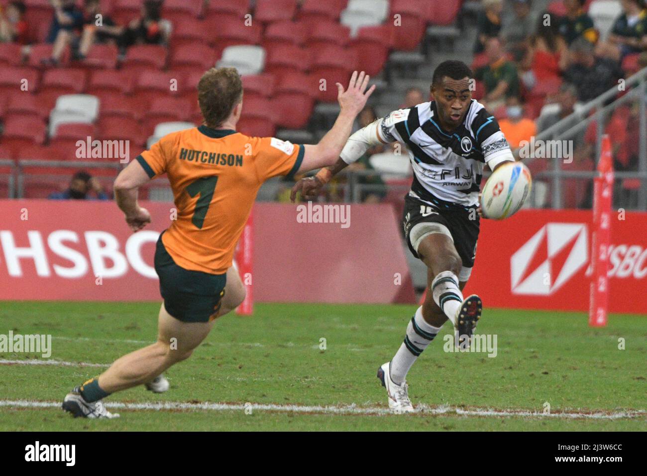 Singapore. 10th Apr, 2022. Vuivawa Naduvalo (R) of Fiji competes during the semifinal between Australia and Fiji at the HSBC World Rugby Sevens Singapore stop, held in the National Stadium on April 10, 2022. Credit: Then Chih Wey/Xinhua/Alamy Live News Stock Photo