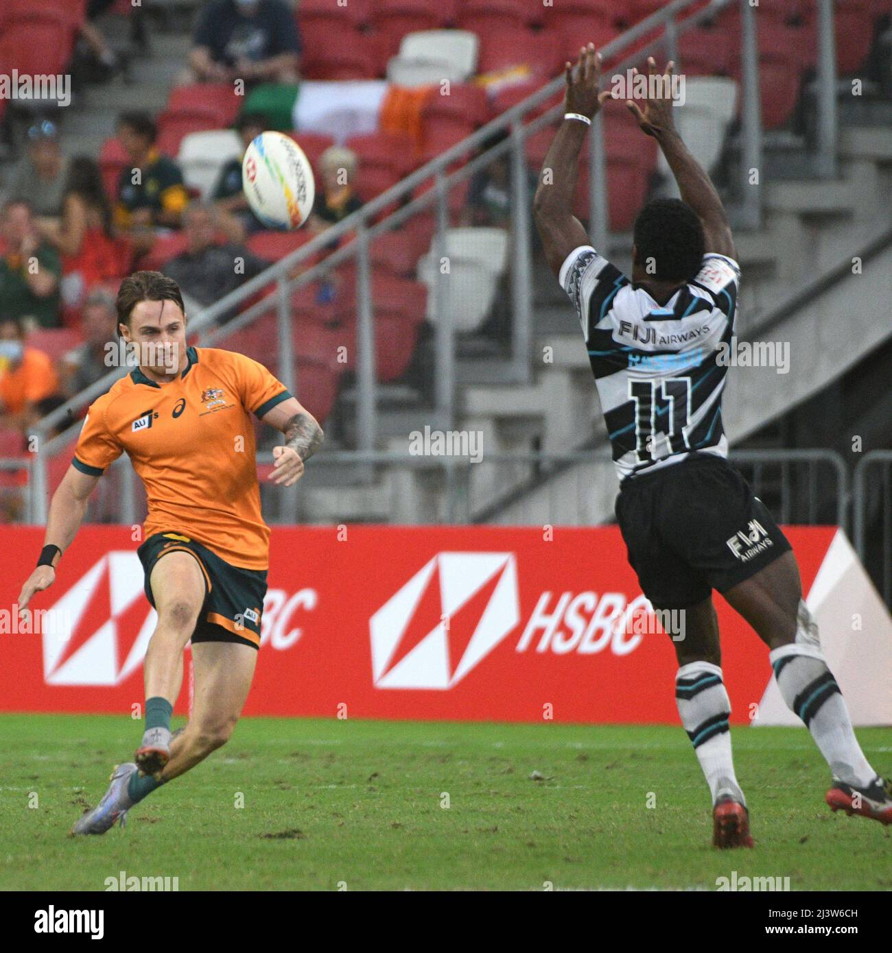 Singapore. 10th Apr, 2022. Corey Toole (L) of Australia competes during the semifinal between Australia and Fiji at the HSBC World Rugby Sevens Singapore stop, held in the National Stadium on April 10, 2022. Credit: Then Chih Wey/Xinhua/Alamy Live News Stock Photo
