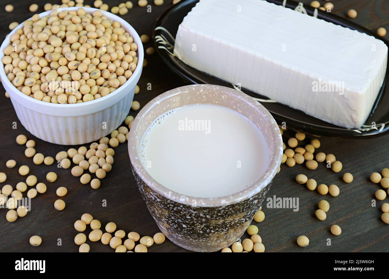 Cup of Soy Milk with Soft Tofu Bean Curd and Dried Soybeans Pile in the