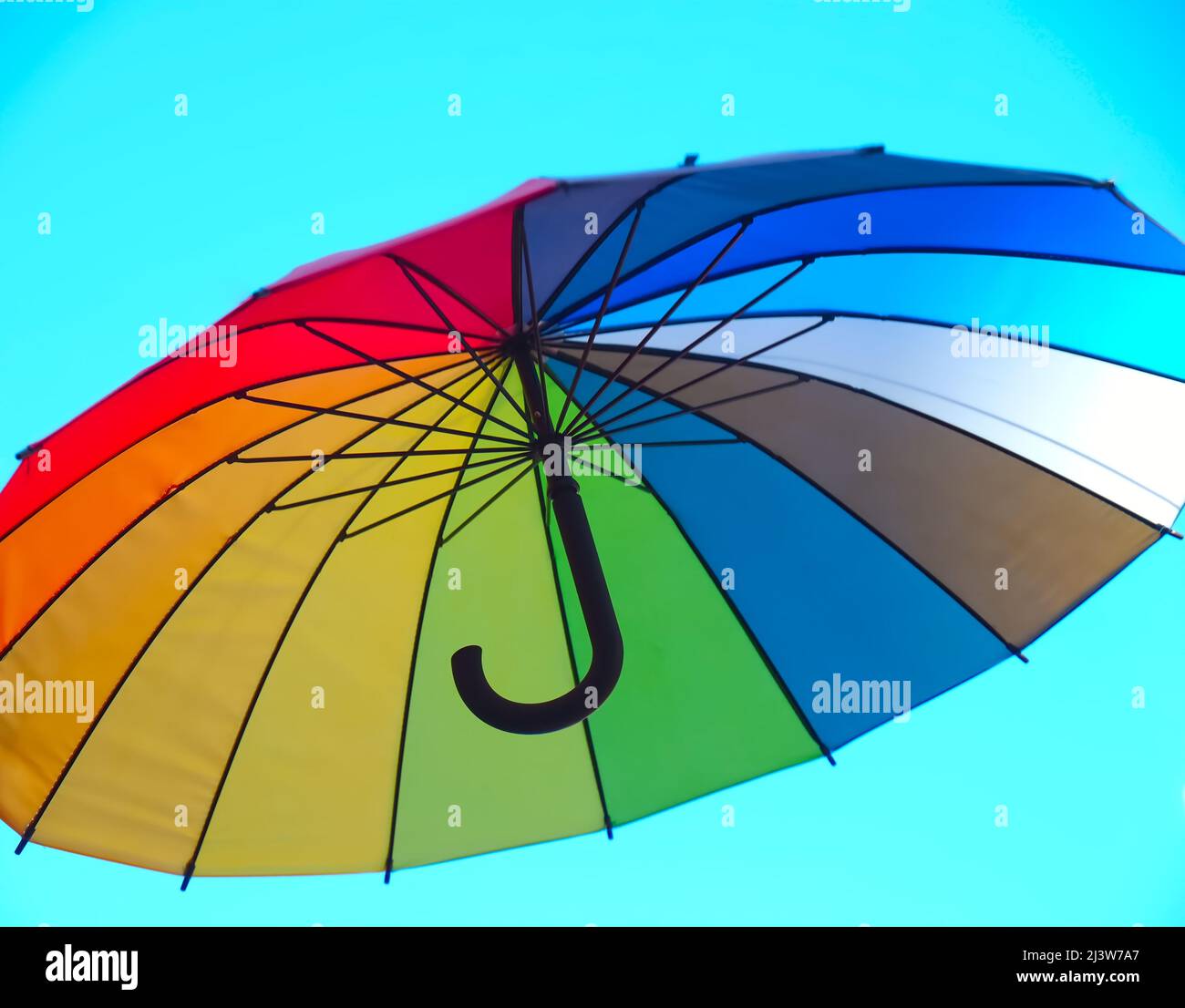 Isolated opened umbrella in rainbow colours Stock Photo