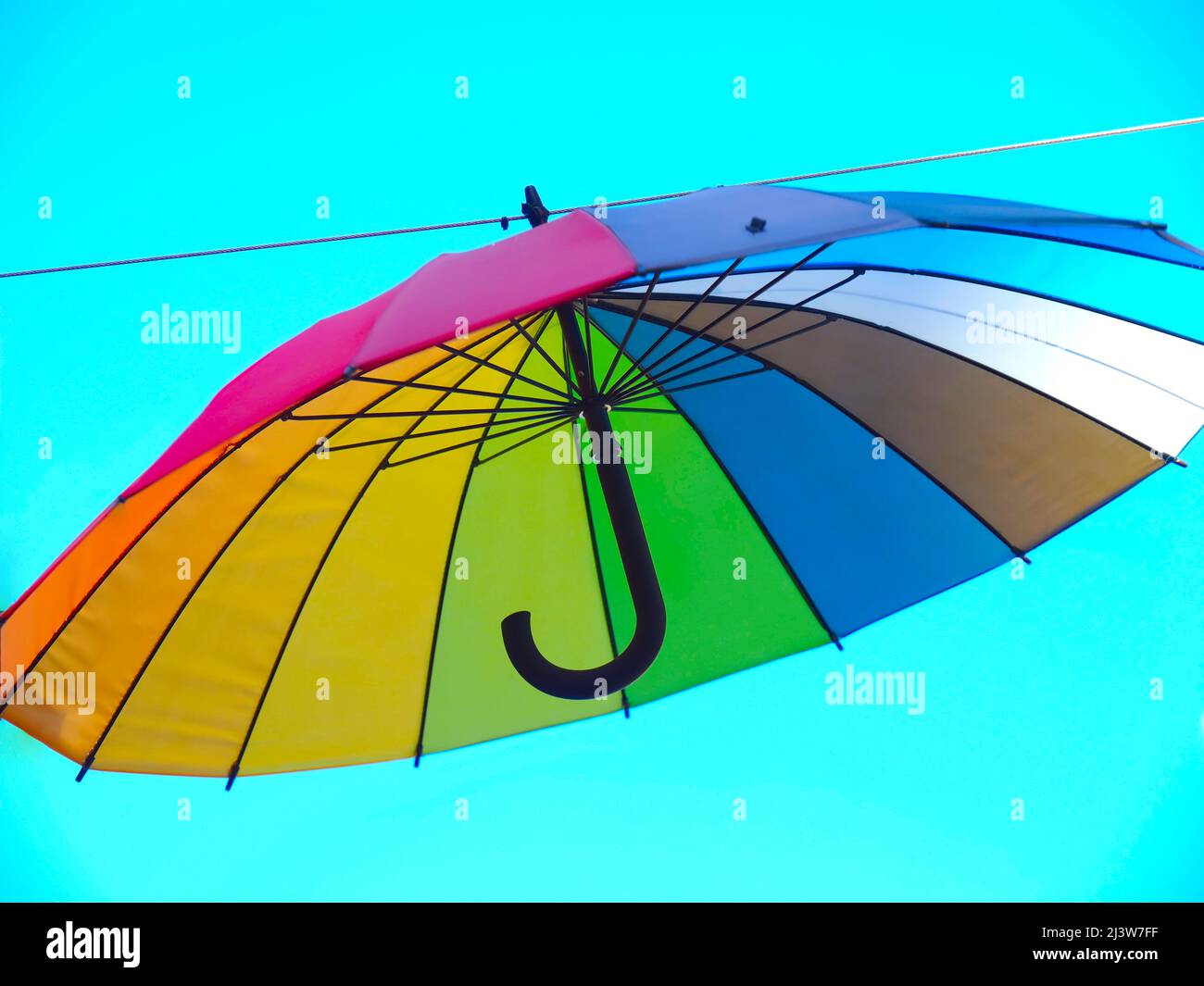 Isolated opened umbrella in rainbow colours Stock Photo