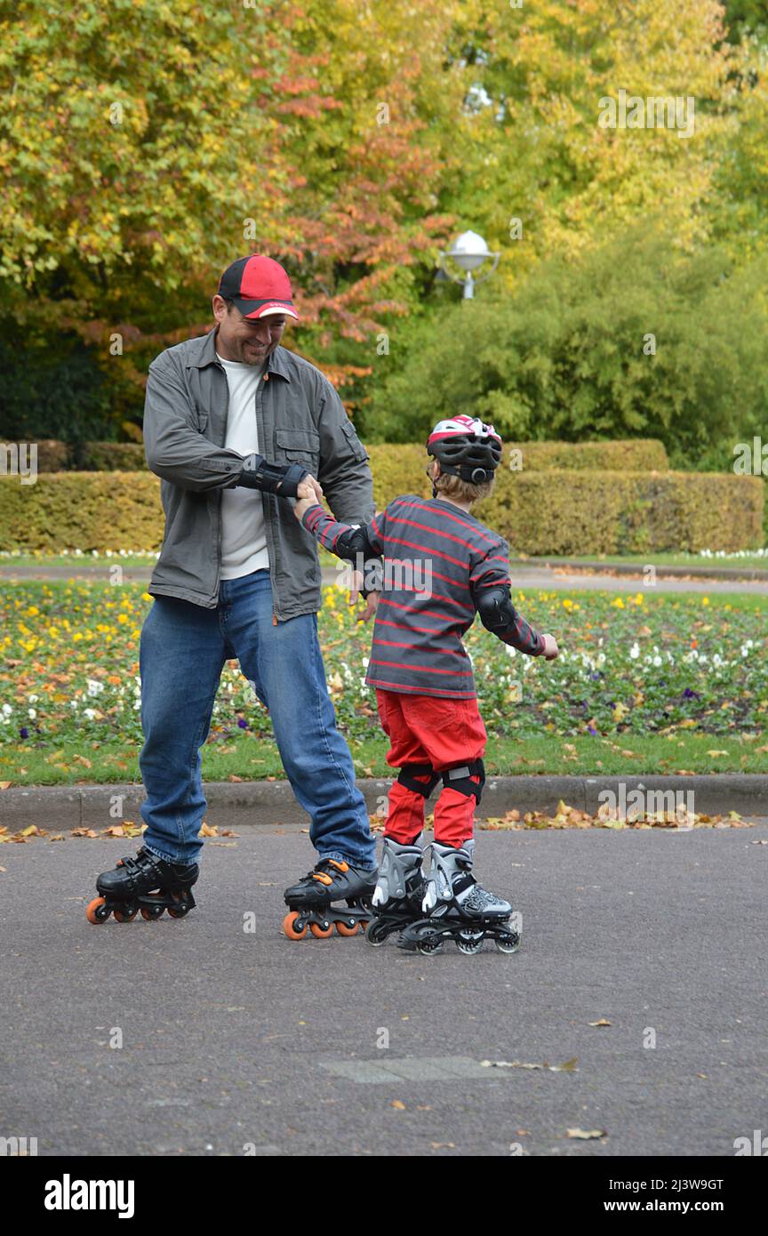 father and son skating Stock Photo