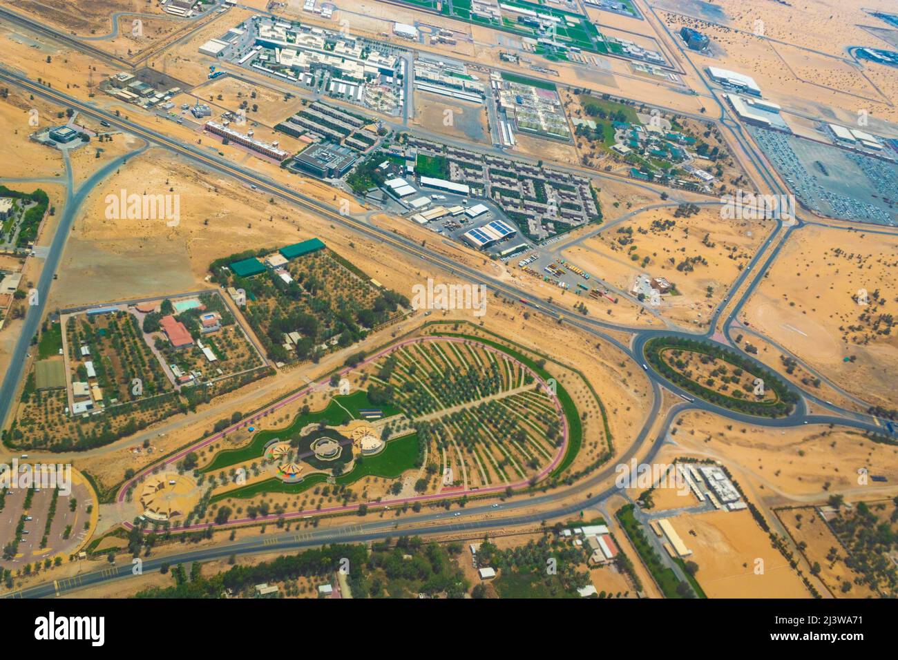 Aerial view of Al Nakheel Park-city park in the desert in the vicinity of Dubai city designed in the form of palm at United Arab Emirates, May 2021 Stock Photo