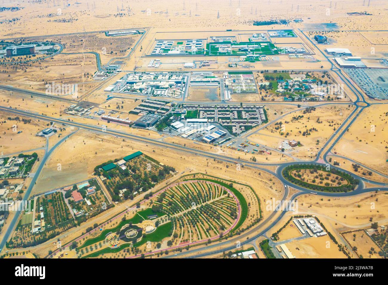 Aerial view of Al Nakheel Park-city park in the desert in the vicinity of Dubai city designed in the form of palm at United Arab Emirates, May 2021 Stock Photo