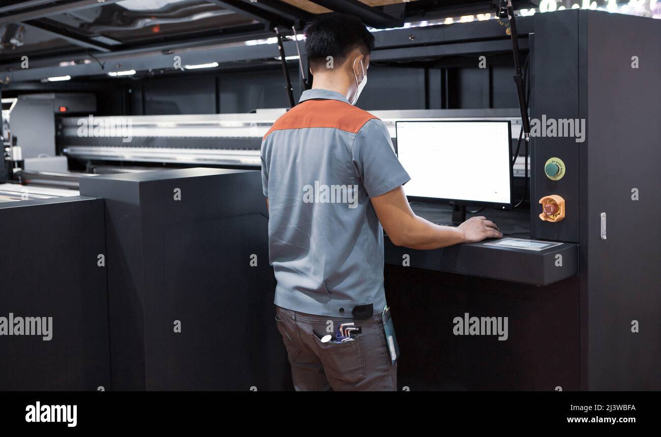 Industrial technician operating corrugated cardboard digital inkjet