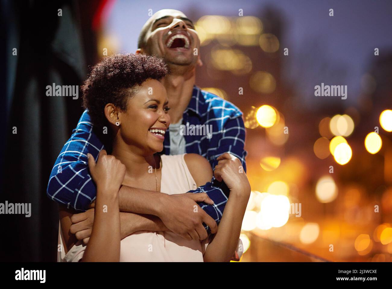 In love and laughter. Cropped shot of an affectionate young couple out on a date in the city. Stock Photo