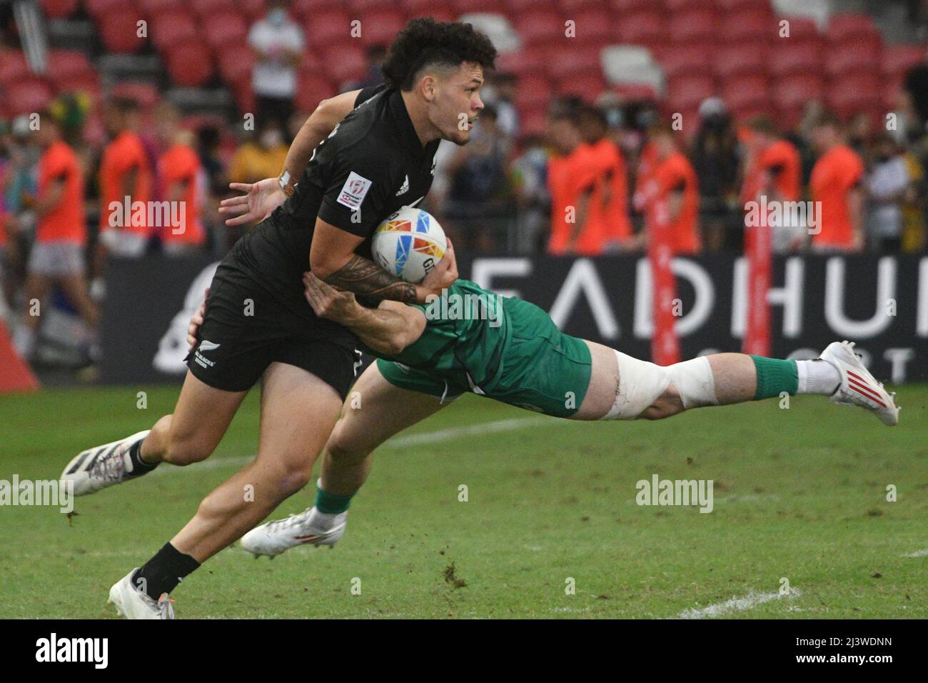 Singapore. 10th Apr, 2022. Caleb Tangitau (L) of New Zealand competes during the semifinal between Ireland and New Zealand at the HSBC World Rugby Sevens Singapore stop, held in the National Stadium on April 10, 2022. Credit: Then Chih Wey/Xinhua/Alamy Live News Stock Photo