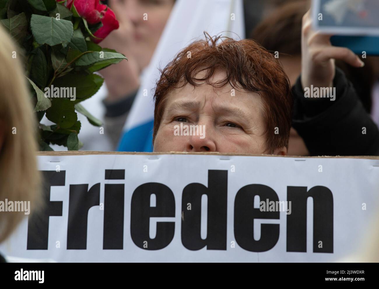 Frankfurt am Main, Germany. 10 April 2022, Hessen, Frankfurt/Main: 'Peace' is written on the poster of this participant of a pro-Russian demonstration in Frankfurt am Main. The police accompanied the rally with several hundred units. The demonstration was announced under the motto 'Against agitation and discrimination of Russian-speaking fellow citizens/Against war - for peace'. Photo: Boris Roessler/dpa Credit: dpa picture alliance/Alamy Live News Stock Photo