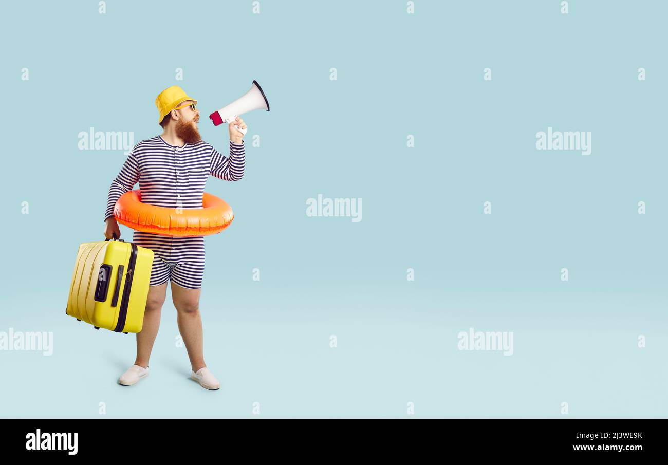 Funny man with megaphone on light blue background announces interesting