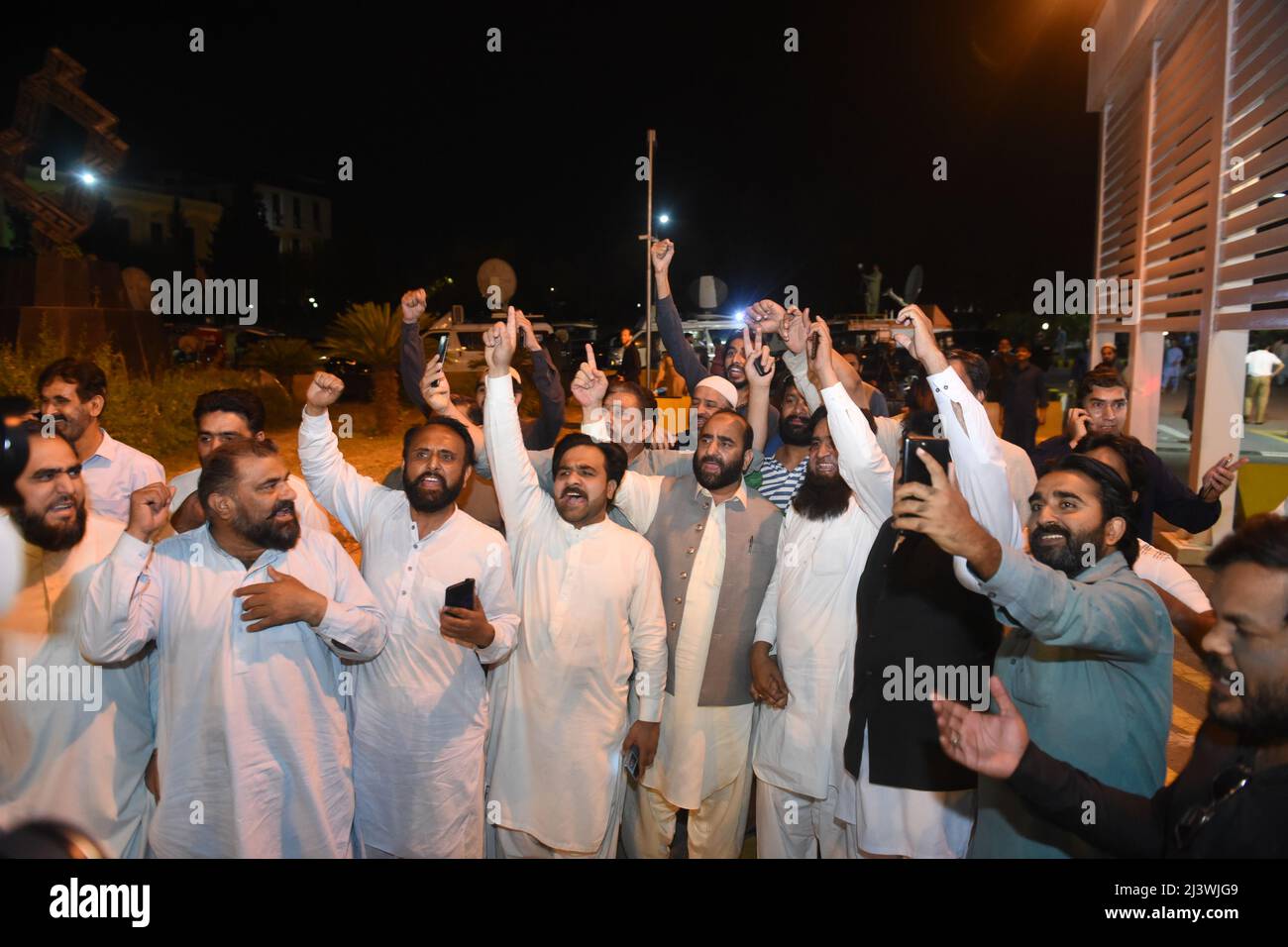 April 10, 2022, Islamabad, Pakistan: People gather in front of parliament building after Pakistan's parliament voted out Prime Minister Imran Khan in a no-confidence motion late Saturday, capping a month-long political turmoil that gripped the nation of 220 million, in Islamabad, Pakistan, on April 09, 2022. As many as 174 lawmakers voted in favor of the no-trust motion, two more than the required 172 for a simple majority in the 324-member National Assembly, the lower house of parliament. It is the first time a Pakistani prime minister has ever been ousted by a no-confidence motion put forwar Stock Photo