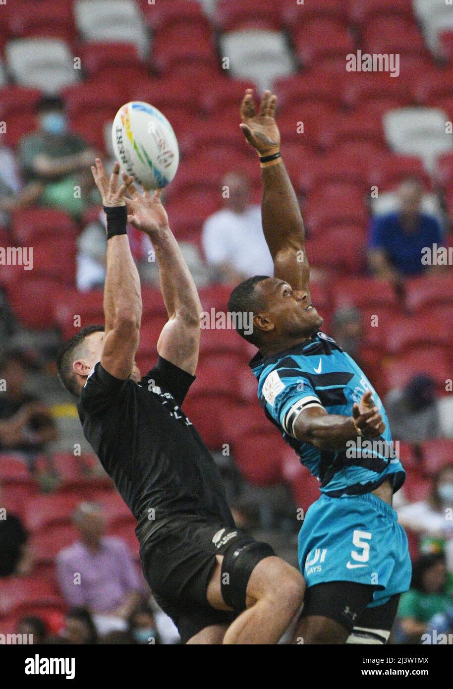 Singapore. 10th Apr, 2022. Elia Canakaivata (R) of Fiji competes with Sam Dickson of New Zealand during the final at the HSBC World Rugby Sevens Singapore stop, held in the National Stadium on April 10, 2022. Credit: Then Chih Wey/Xinhua/Alamy Live News Stock Photo