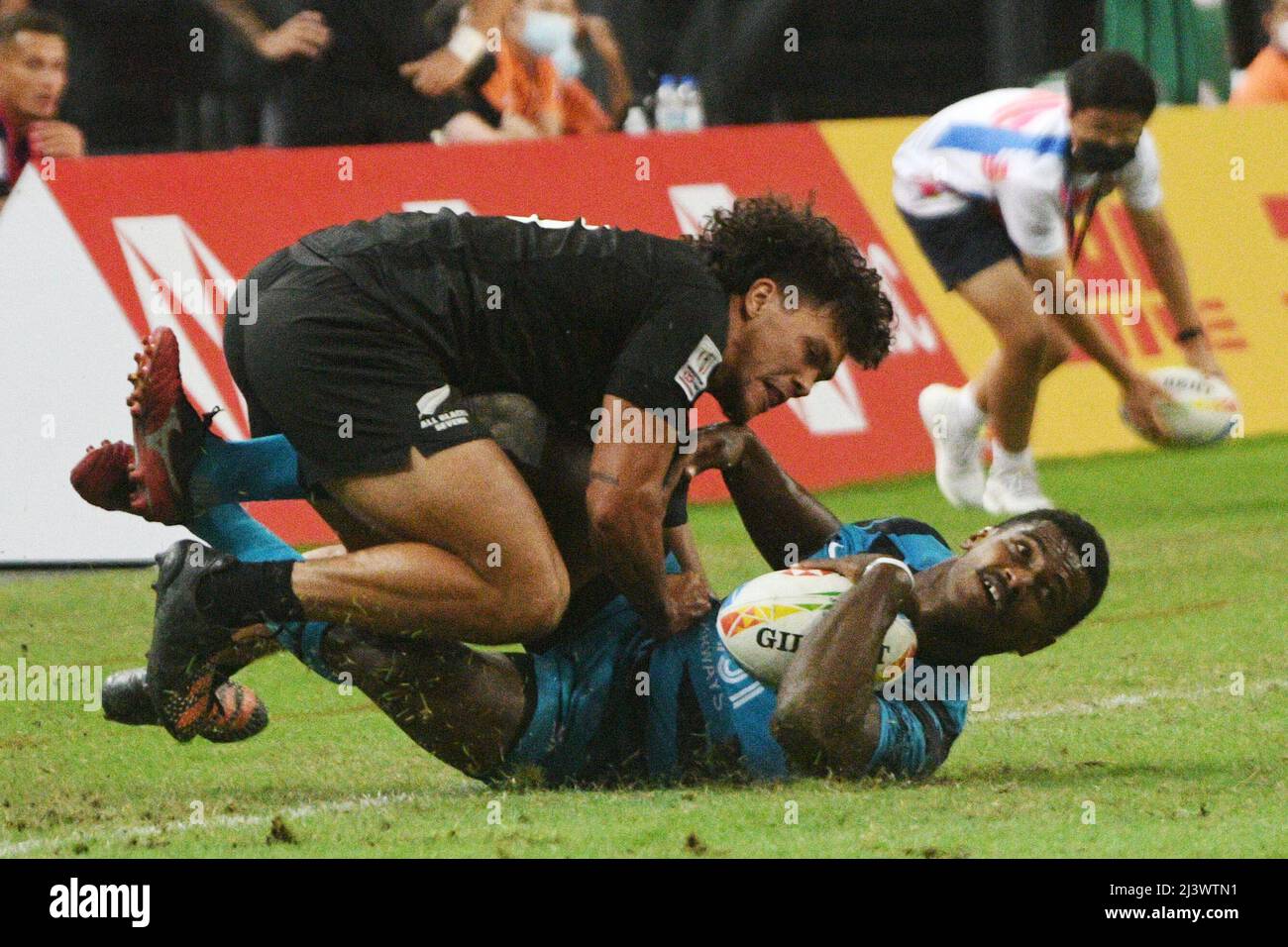 Singapore. 10th Apr, 2022. Kaminieli Rasaku (bottom) of Fiji competes during the final between New Zealand and Fiji at the HSBC World Rugby Sevens Singapore stop, held in the National Stadium on April 10, 2022. Credit: Then Chih Wey/Xinhua/Alamy Live News Stock Photo