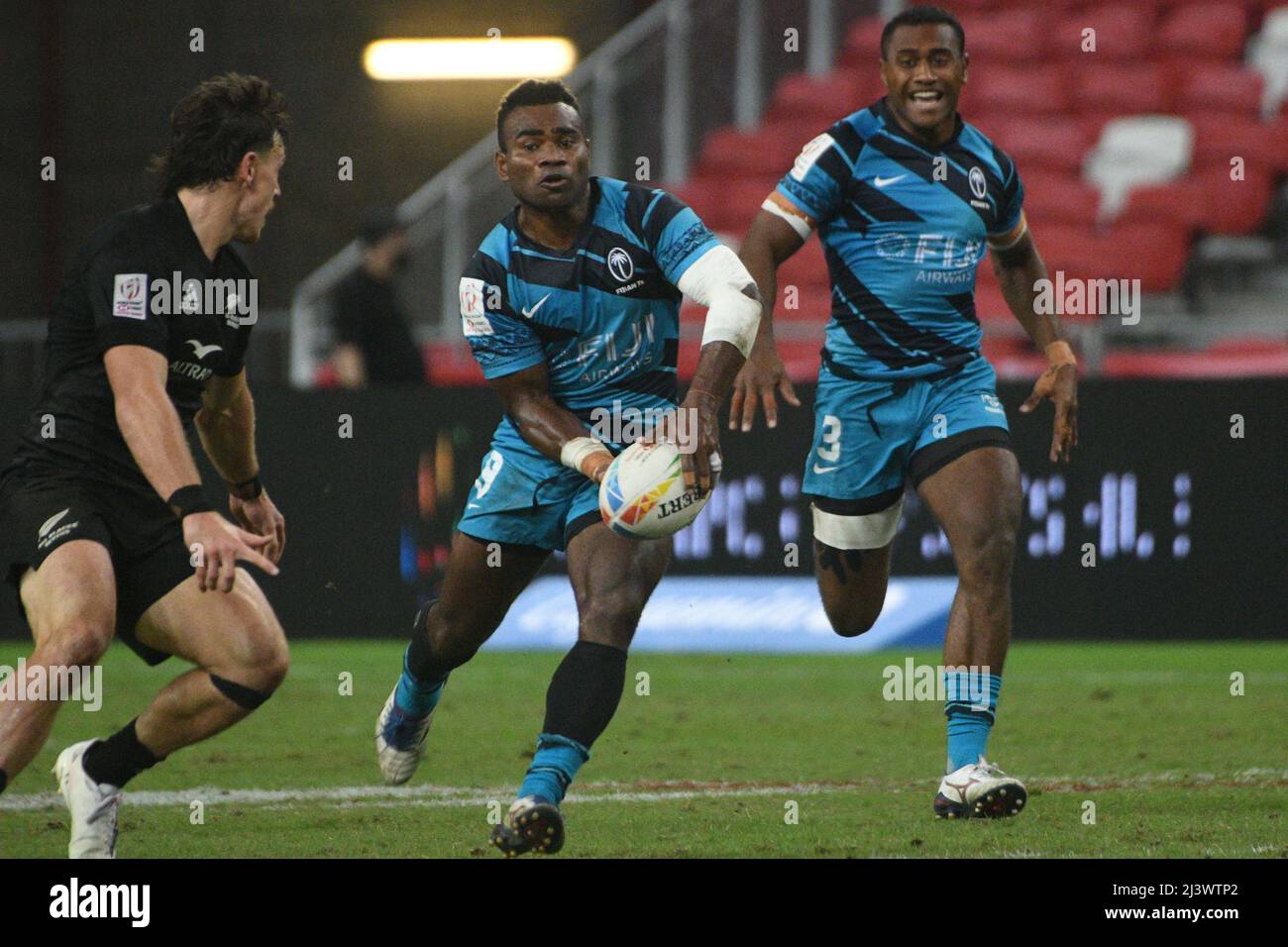 Singapore. 10th Apr, 2022. Jerry Tuwai (C) of Fiji competes during the final between New Zealand and Fiji at the HSBC World Rugby Sevens Singapore stop, held in the National Stadium on April 10, 2022. Credit: Then Chih Wey/Xinhua/Alamy Live News Stock Photo