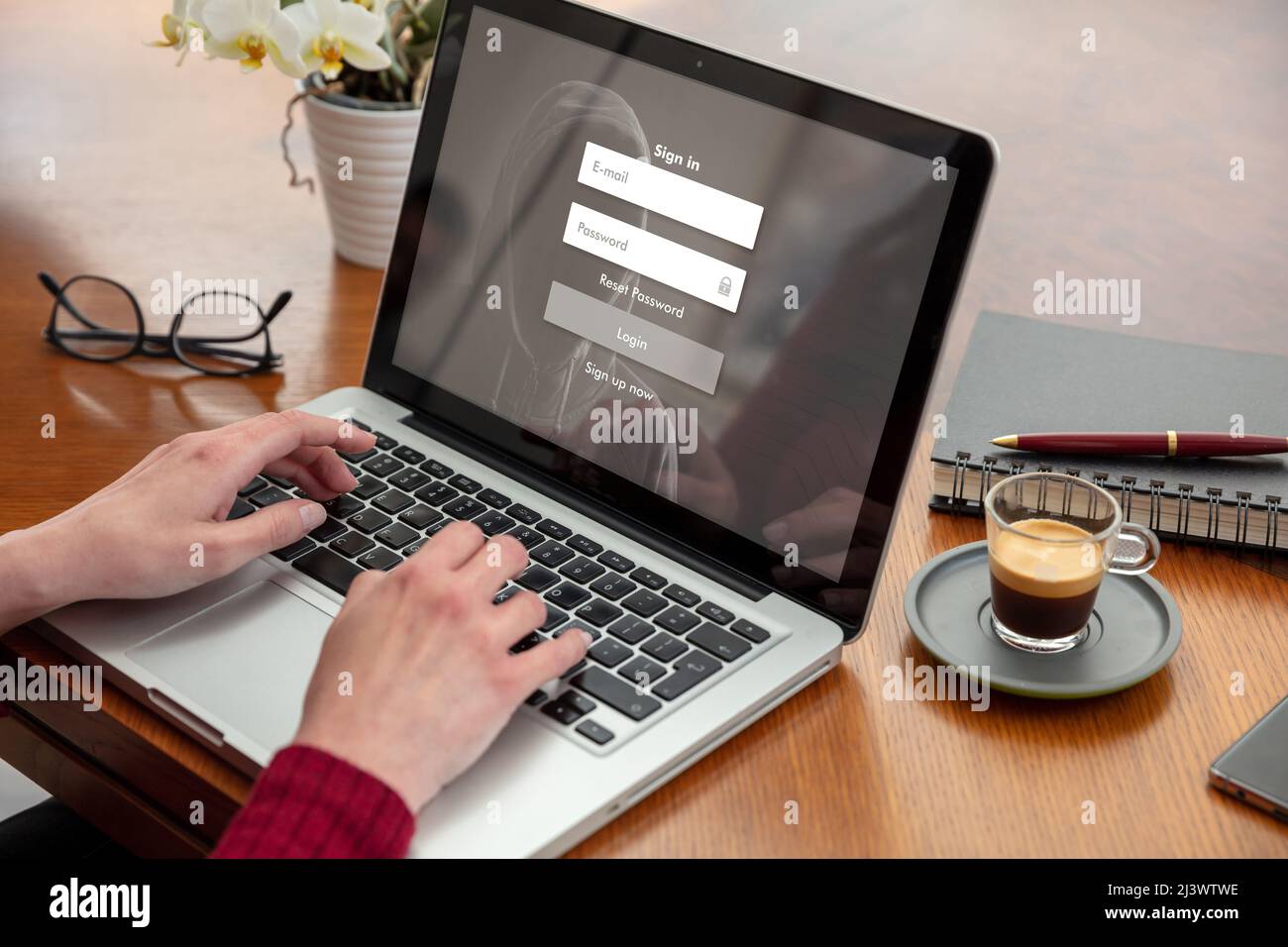 Password login on computer screen, cyber lock internet security concept. Woman working with a laptop. Office business wood table background. Stock Photo