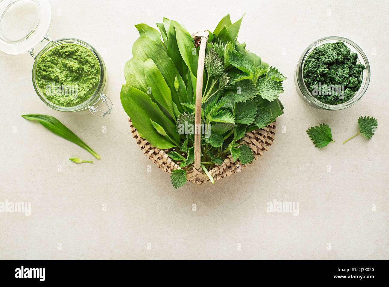 Spring healthy food. Nettle and ramson pesto for healthy meal on grey background Stock Photo
