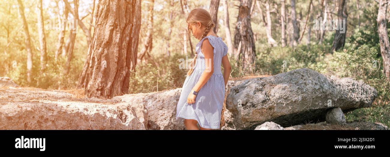 kid girl traveler of eight years old travel and explore the ancient excavations of the ruins of the ancient Lycian city of Phaselis in Turkey in summe Stock Photo