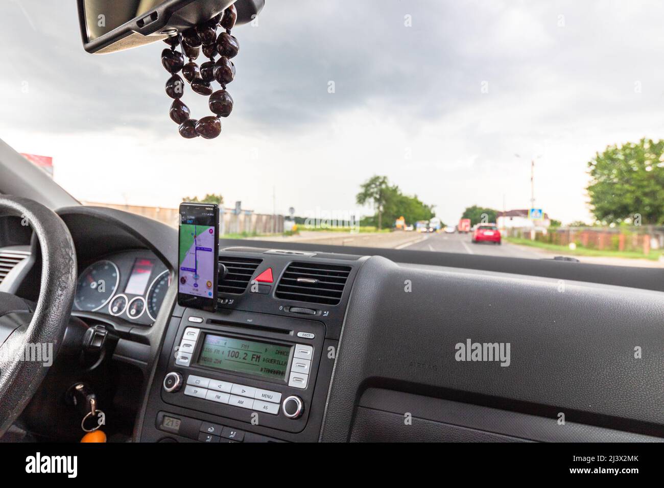 Using waze maps application on smartphone on car dashboard, Driver ...
