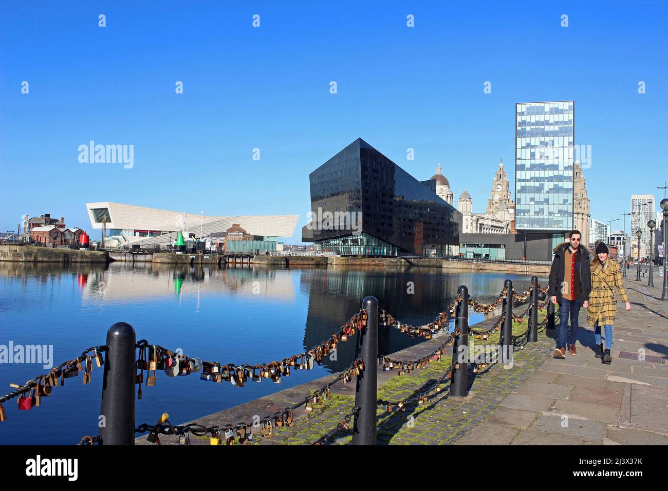 Young Couple Walking Along The Strand Beside Canning Dock - with  Museum of Liverpool, Open Eye Gallery & RIBA Offices, Waterfront,  UK Stock Photo