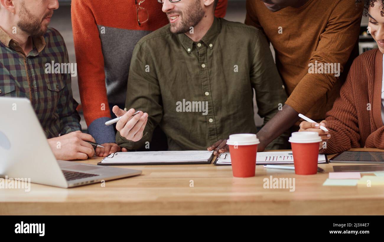 business man explaining something to his colleagues . Stock Photo