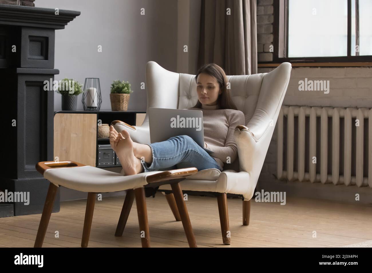 Focused freelance woman in casual working on online project Stock Photo