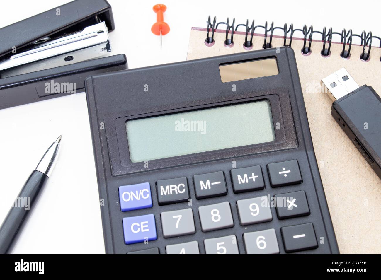 Accounting fraud. Black bookkeeping. Modern office calculator on the table on a dark background Stock Photo