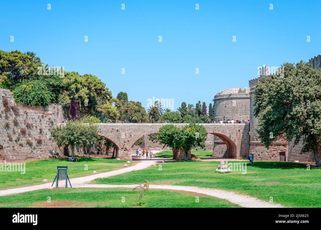 Rhodes, Greece - August 20 2014: View of the medieval moat and the d'Amboise Gate on a sunny summer day. Stock Photo