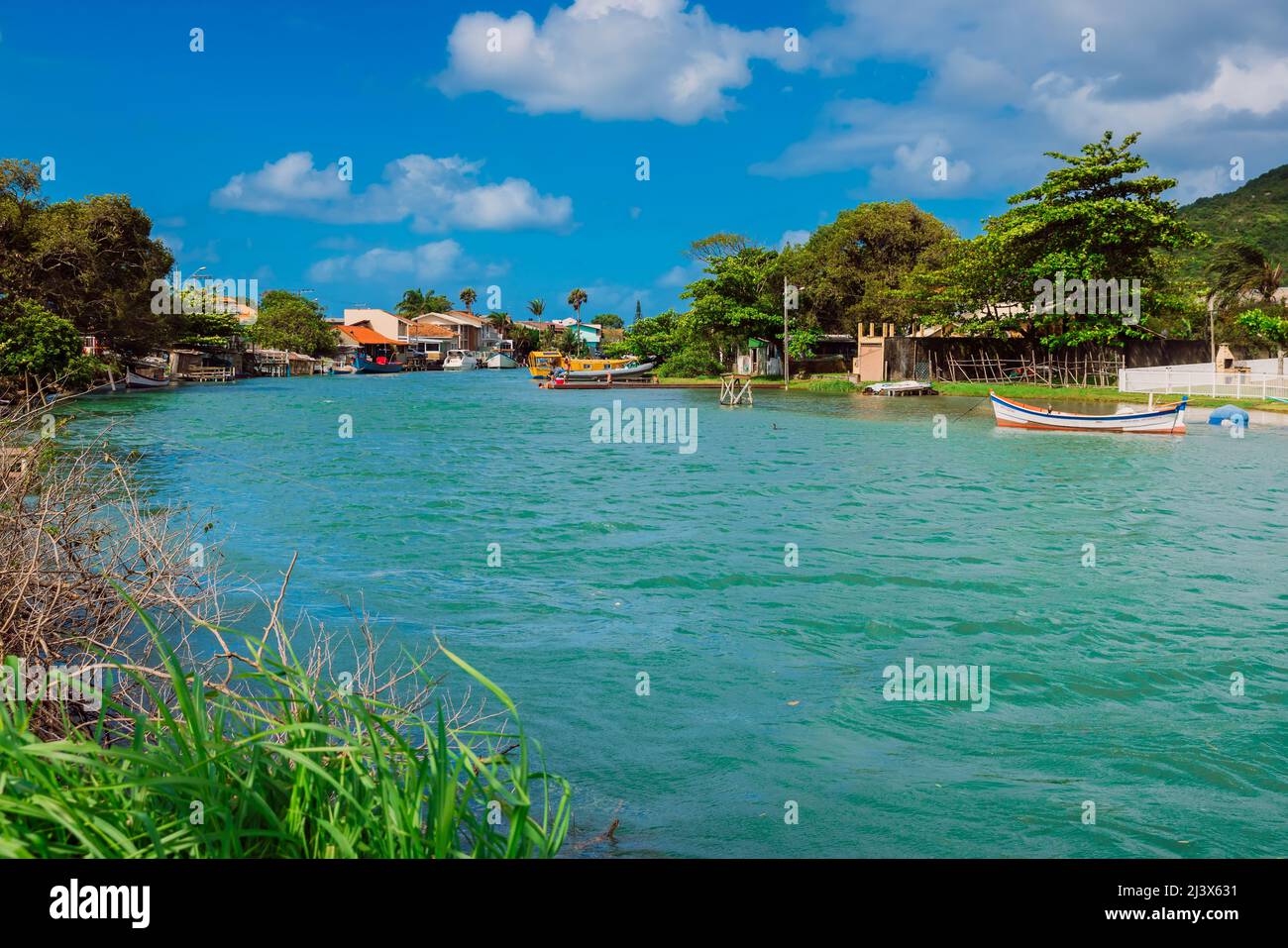 January 6, 2022. Florianopolis, Brazil. Canal of Barra da Lagoa with blue water, boats and houses Stock Photo