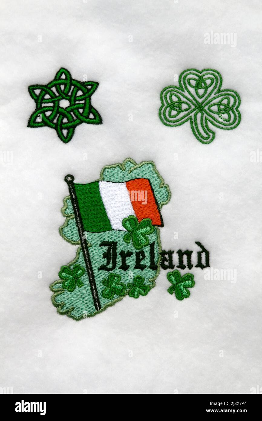 Ireland decoration, map outline, flag, shamrocks, Celtic symbols, white felt fabric, machine embroidery, art, craft, texture, words, text, PR Stock Photo