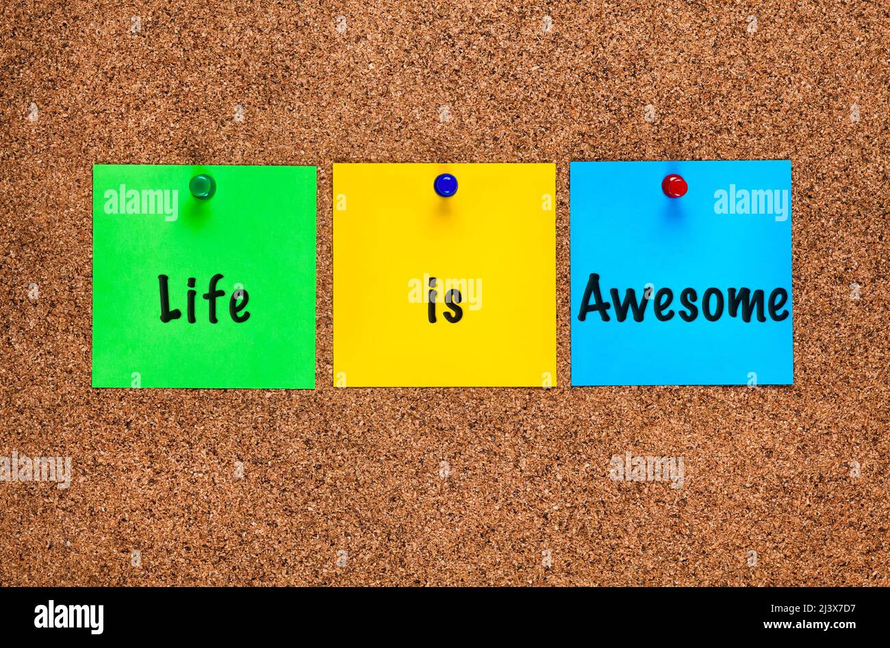 Three colored notes on a corkboard with words Life is Awesome. Stock Photo