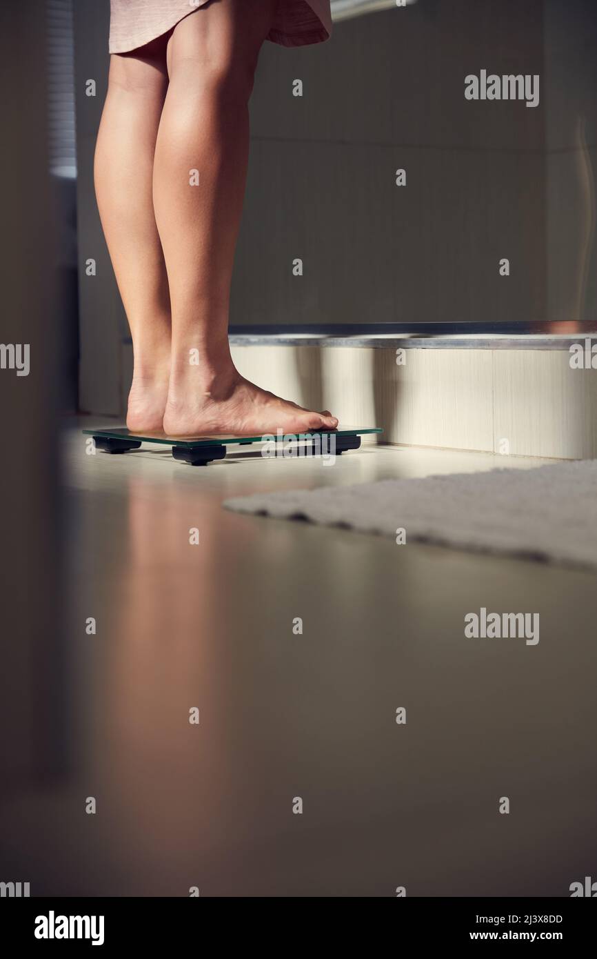 Stop Weighing Yourself Down Shot Of An Unrecognizble Woman Weighing Herself On A Scale At Home Stock Photo Alamy
