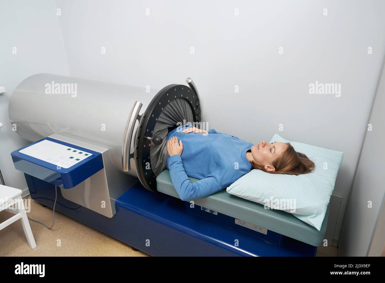 Female patient using vacuumed therapy equipment in clinic Stock Photo
