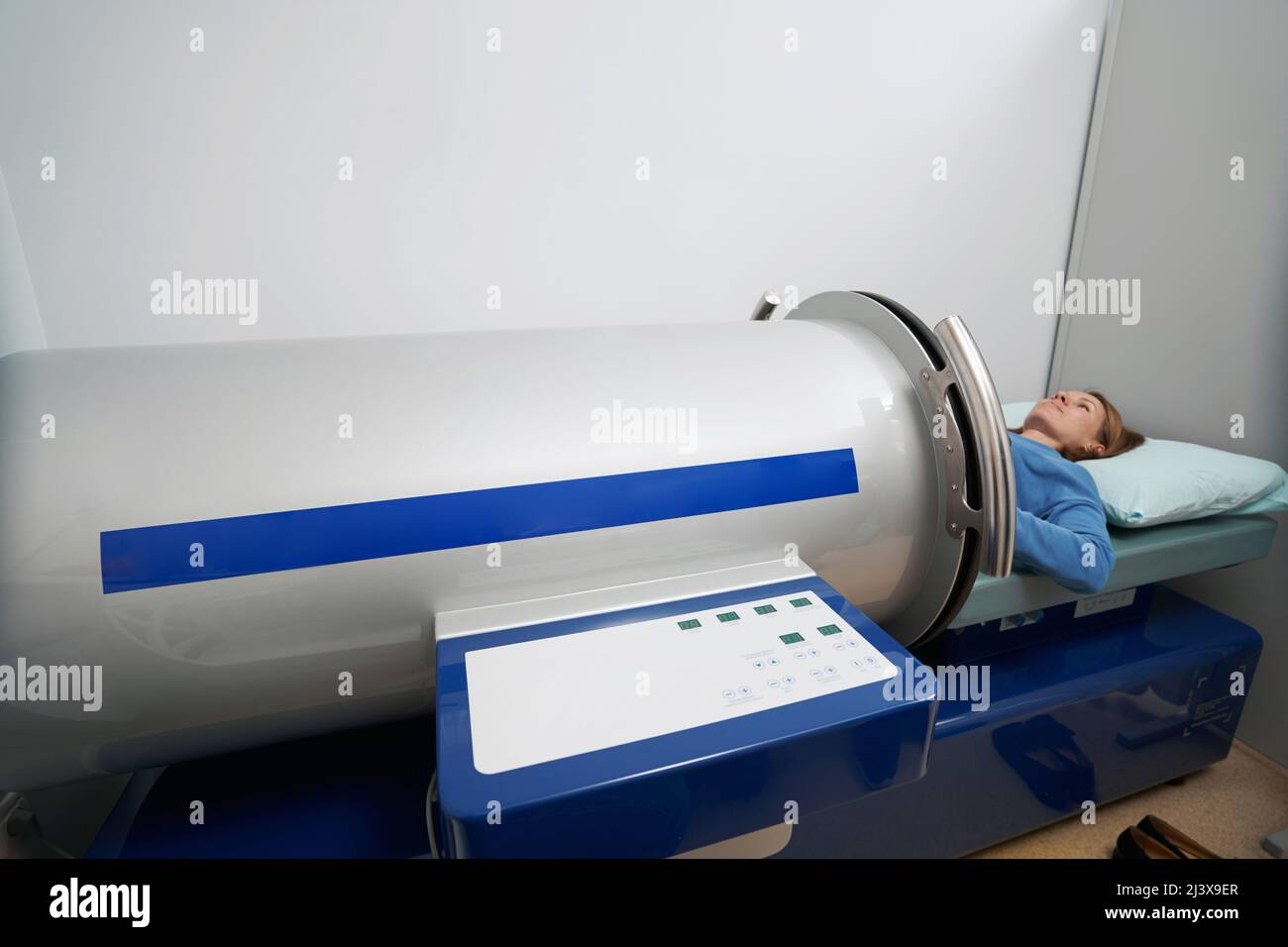 Woman using vacuumed therapy equipment in clinic Stock Photo