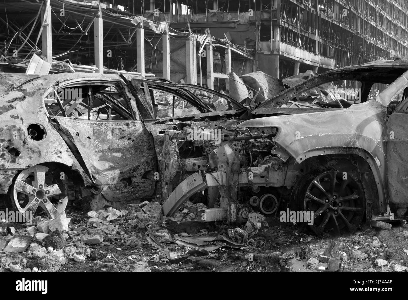 Aftermath shell of civilian bombed city damage car. 2022 Russian invasion of Ukraine war torn city destroyed car burn out. Bomb attack Russia war Stock Photo
