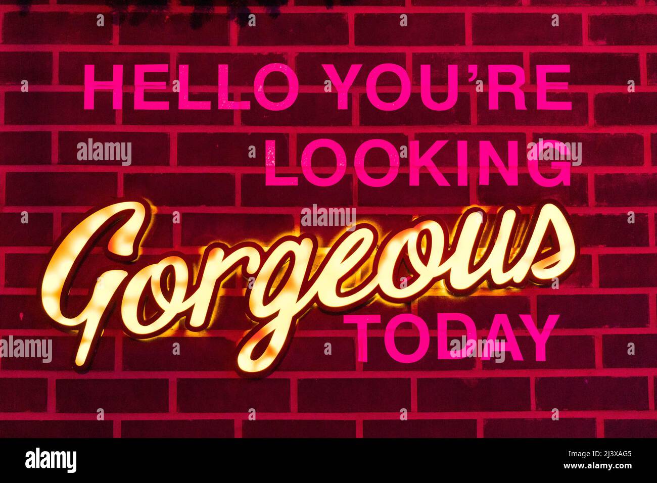 empowering slogan written on a brick wall Stock Photo