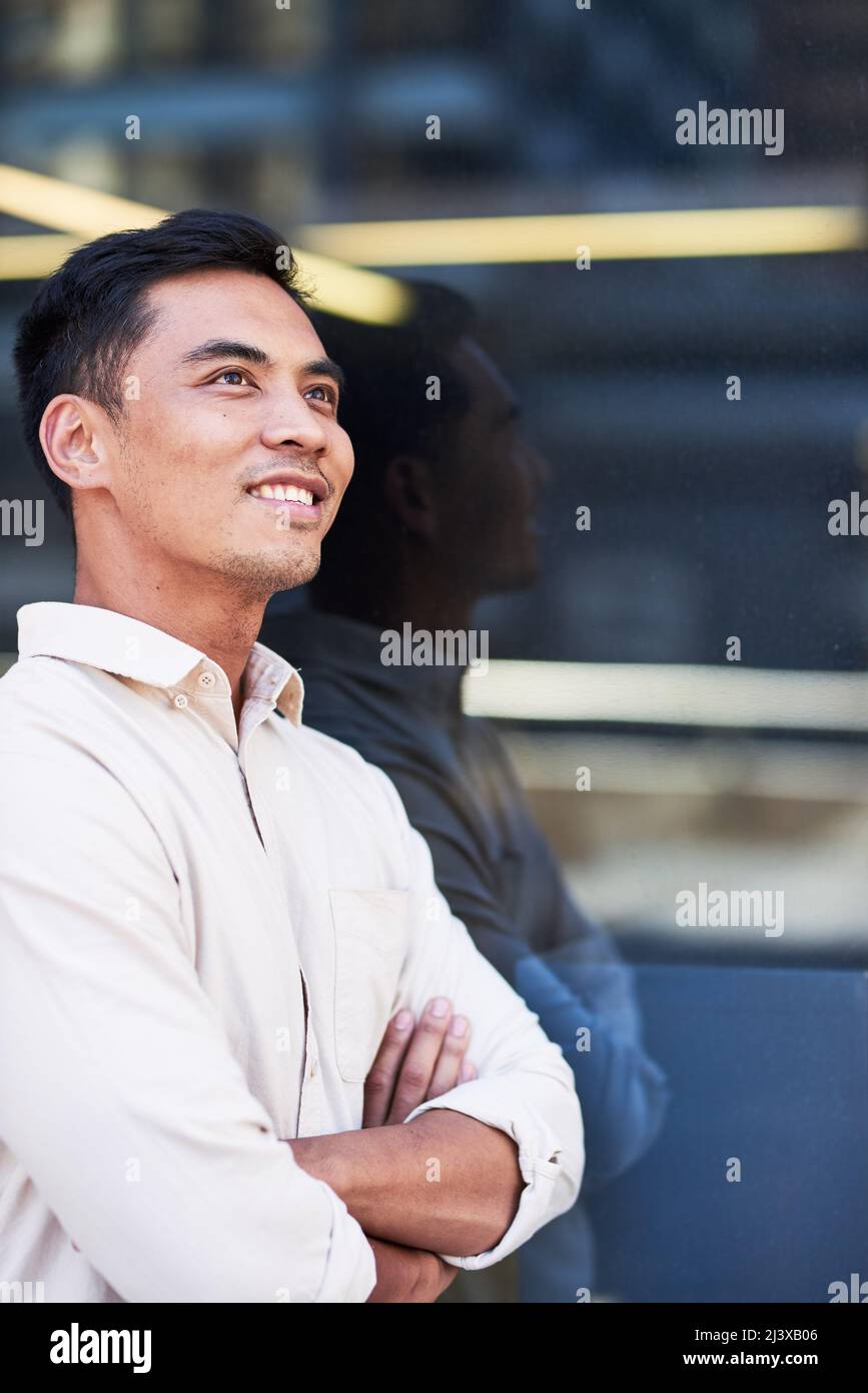 Portrait of a young South East Asian businessman outside an office window Stock Photo