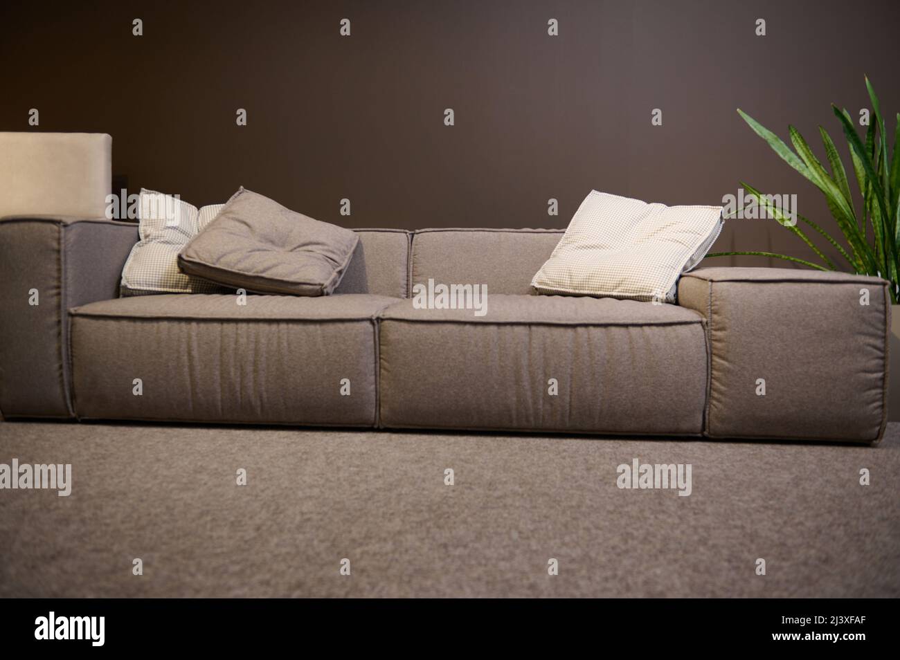 Front view of a large comfortable sofa made of high quality fabrics and ...