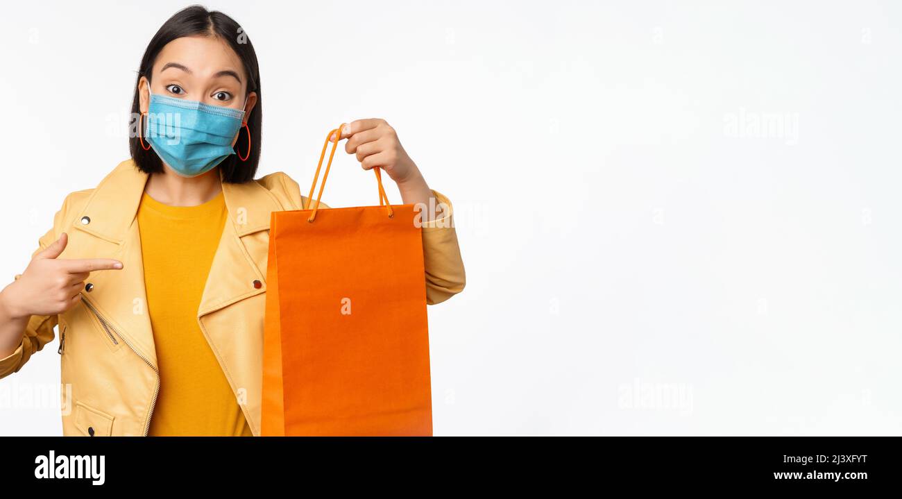 Covid19 and shop concept. Young asian stylish woman, wearing medical