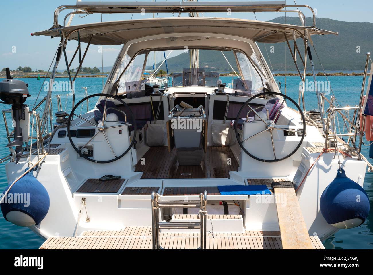 The deck of a sailing yacht anchored in the port. Two steering wheels