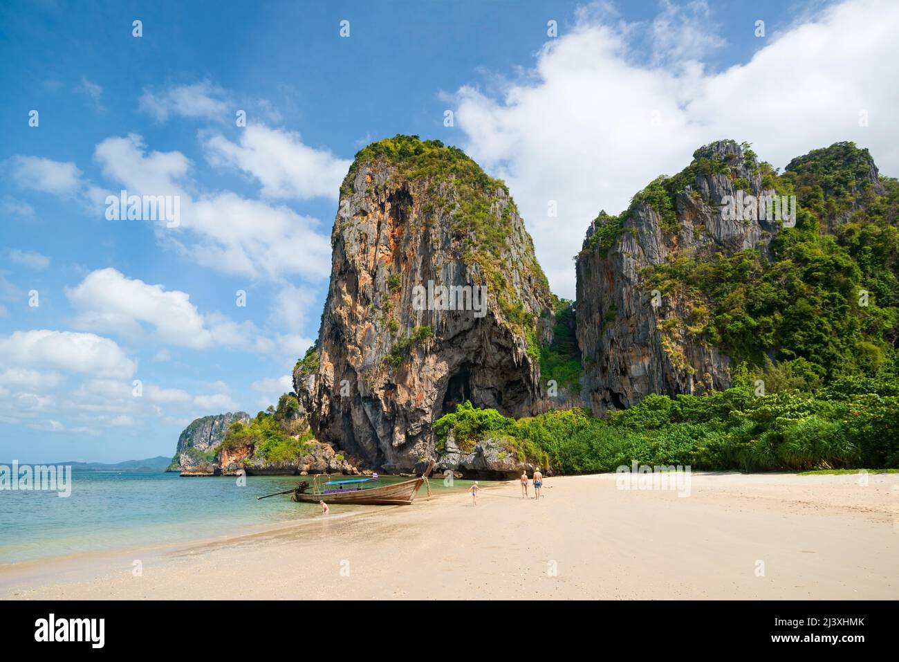 Amazing tropical view of Phra Nang Beach. People on the white sand, long-tail boats in the sea, Ao Nang, Krabi, Thailand Stock Photo