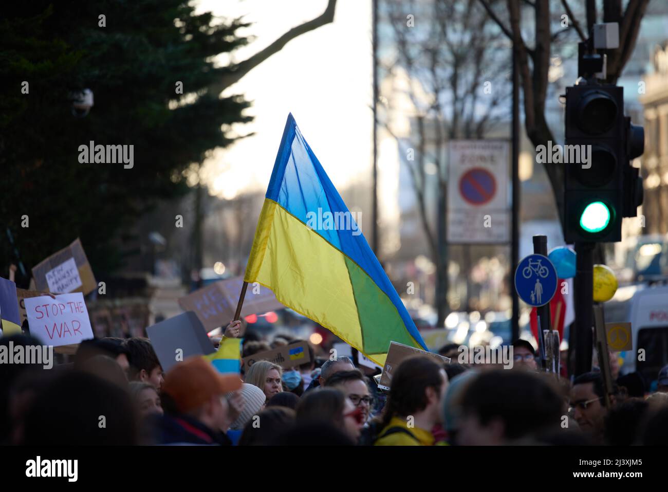 Stand for Ukraine protest, London near Russian embassy, crow on the street holding Ukrainian flag standing up for democracy and human rights Stock Photo