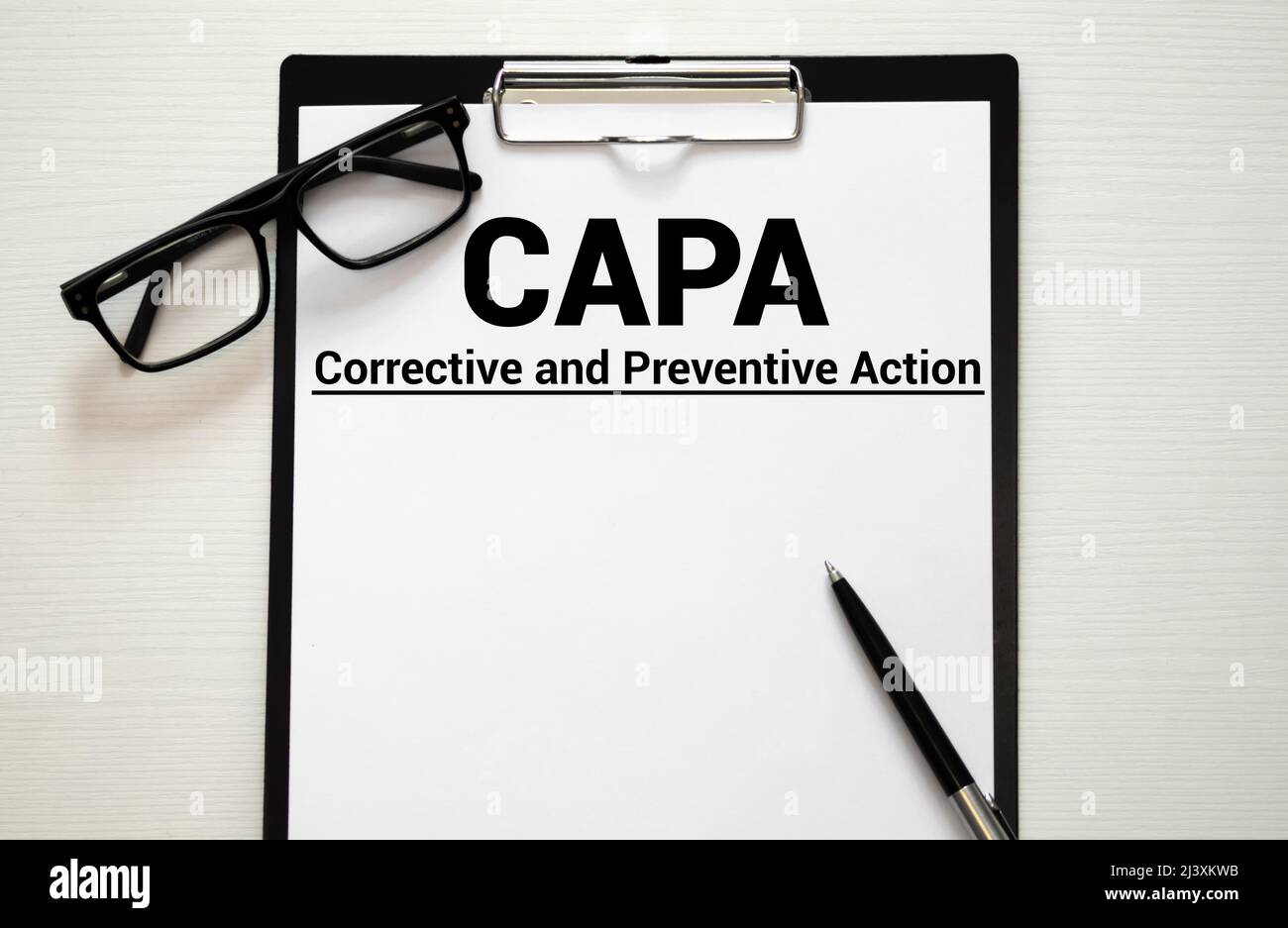 Paper with words CAPA Corrective and Preventive action plans. Stock Photo