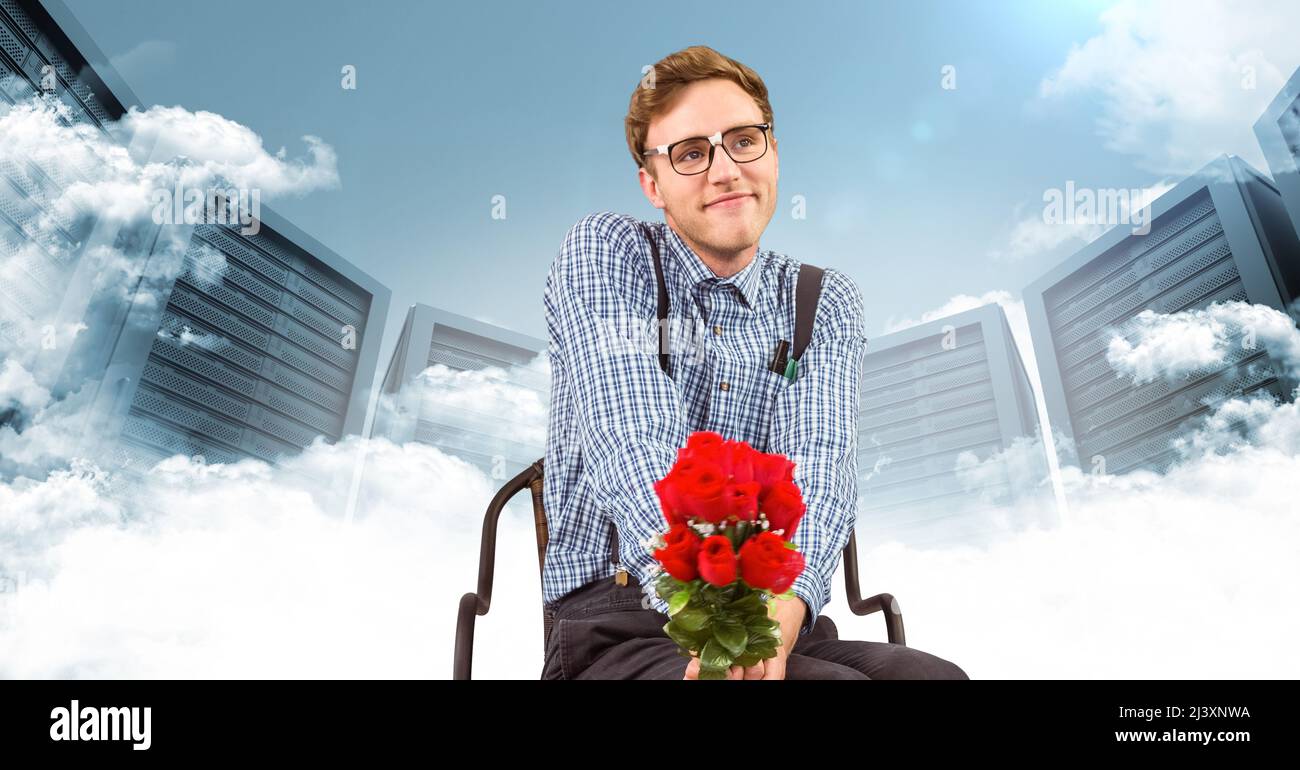 Caucasian man with bunch of roses sitting on a chair against computer ...
